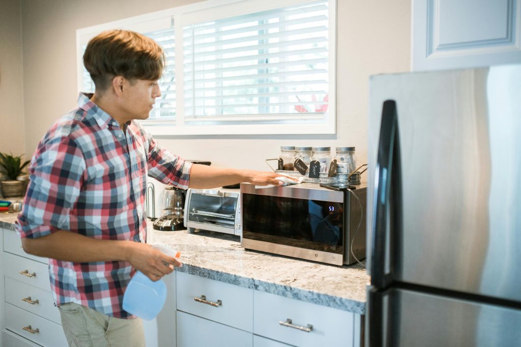 a person cleaning oven